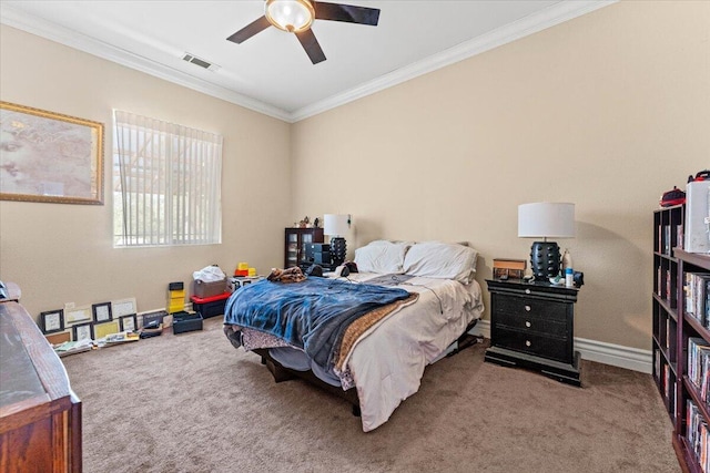 bedroom with ornamental molding, carpet flooring, visible vents, and baseboards
