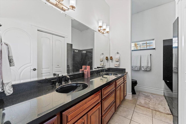 bathroom featuring walk in shower, double vanity, tile patterned flooring, and a sink