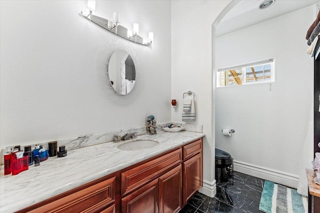 bathroom with vanity and marble finish floor