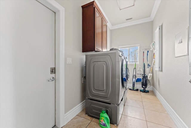 clothes washing area featuring washer and dryer, cabinet space, crown molding, visible vents, and baseboards