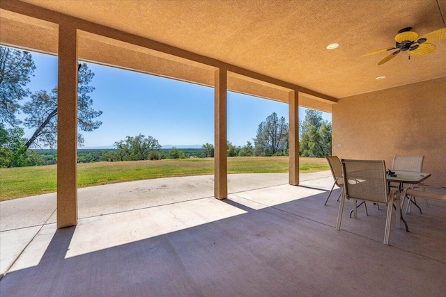 view of patio featuring outdoor dining area and a ceiling fan