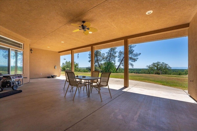 view of patio featuring outdoor dining area and ceiling fan