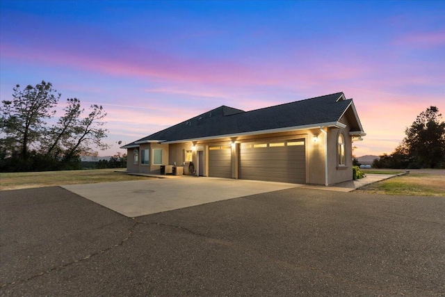 ranch-style home with driveway and an attached garage
