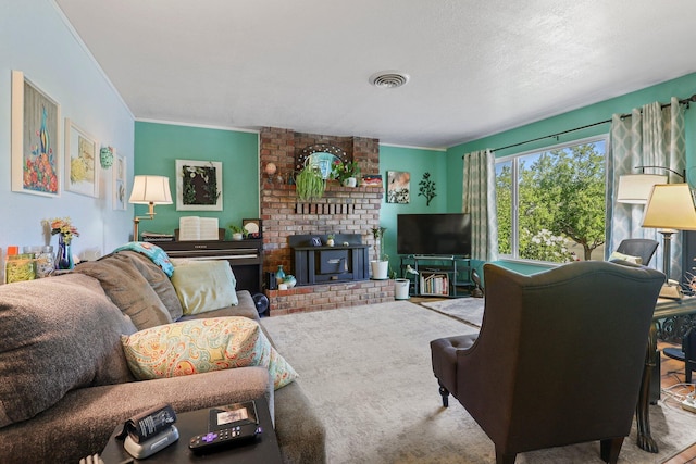 living area featuring visible vents, a fireplace, ornamental molding, and carpet floors