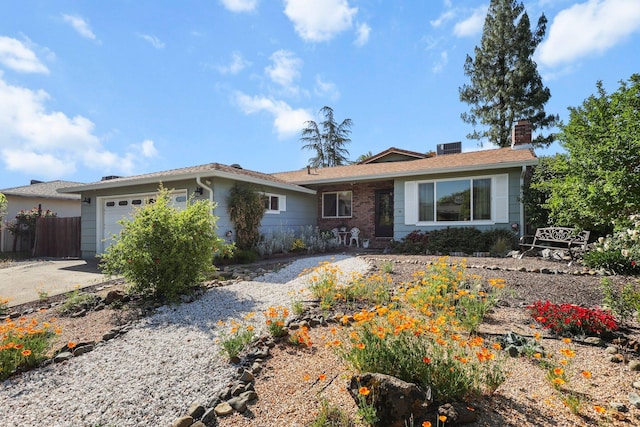 ranch-style house featuring concrete driveway, fence, a chimney, and a garage