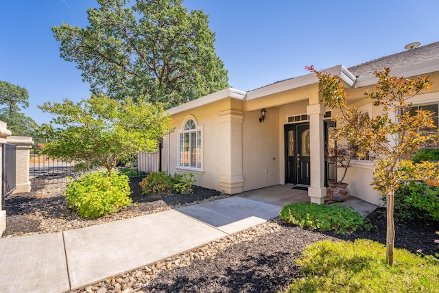view of front of home with fence and stucco siding