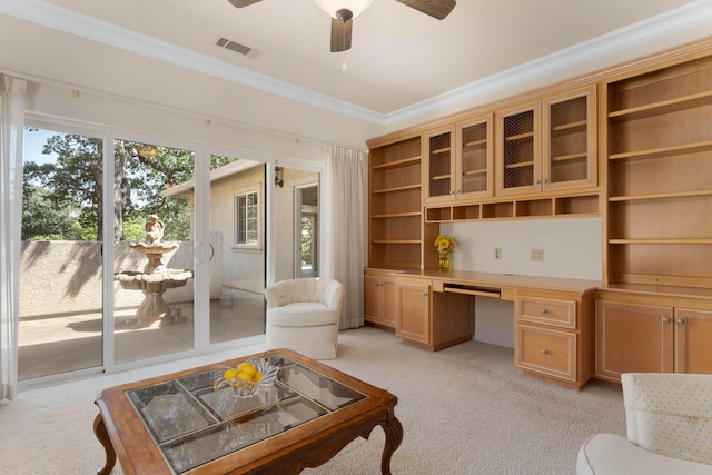 office area featuring built in study area, crown molding, light carpet, and visible vents