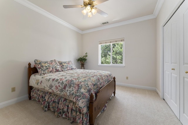 carpeted bedroom with crown molding, a closet, and baseboards