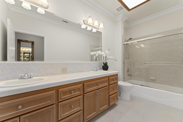 bathroom with ornamental molding, visible vents, and a sink