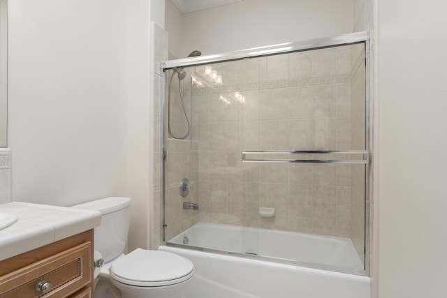 bathroom with toilet, vanity, and shower / bath combination with glass door
