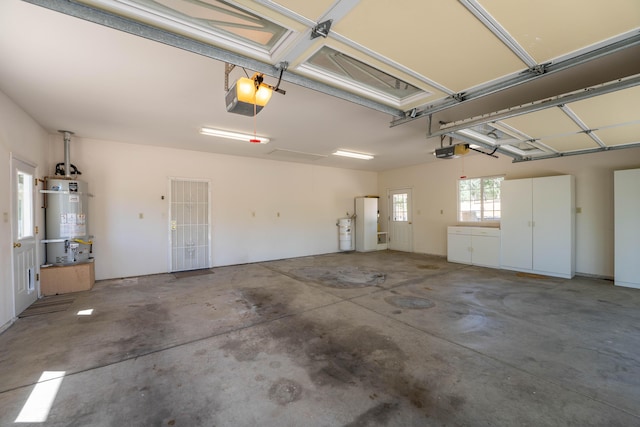garage featuring fridge, secured water heater, and a garage door opener
