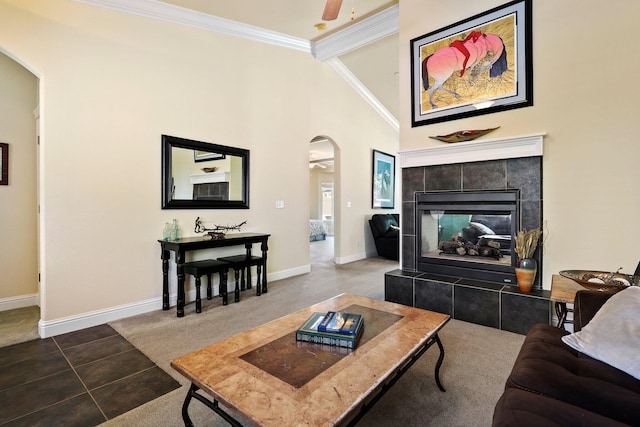 3776 Mario Ave, Redding, CA 96001 - tiled living area featuring a ceiling fan, baseboards, crown molding, arched walkways, and a fireplace