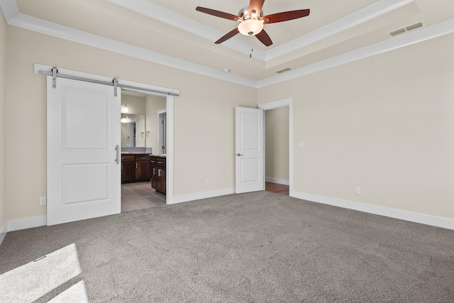 unfurnished bedroom with baseboards, ensuite bathroom, visible vents, and carpet floors