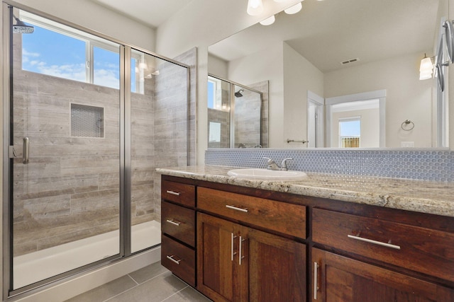 bathroom featuring vanity, a shower stall, visible vents, and tile patterned floors