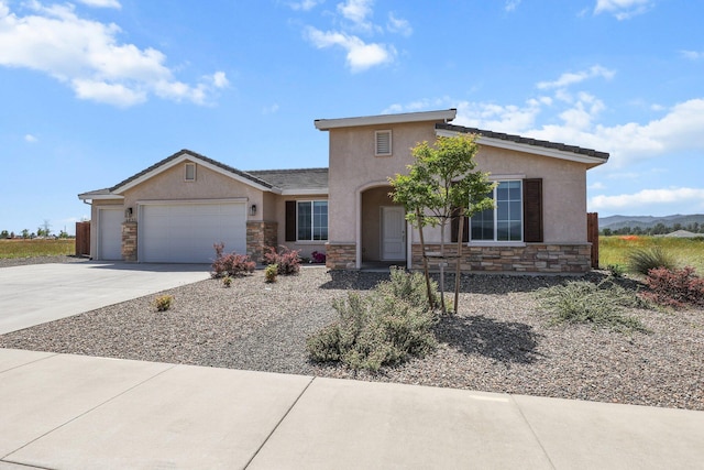 view of front of house with concrete driveway, a garage, stucco siding, and stone siding
