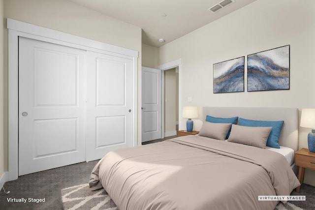 carpeted bedroom featuring a closet, visible vents, and baseboards