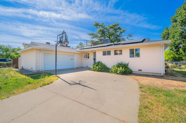 1530 Carmel Way, Red Bluff, CA 96080 - ranch-style home with concrete driveway, roof mounted solar panels, and an attached garage