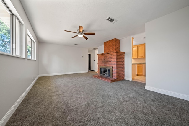 1530 Carmel Way, Red Bluff, CA 96080 - unfurnished living room featuring carpet flooring, ceiling fan, a brick fireplace, and baseboards