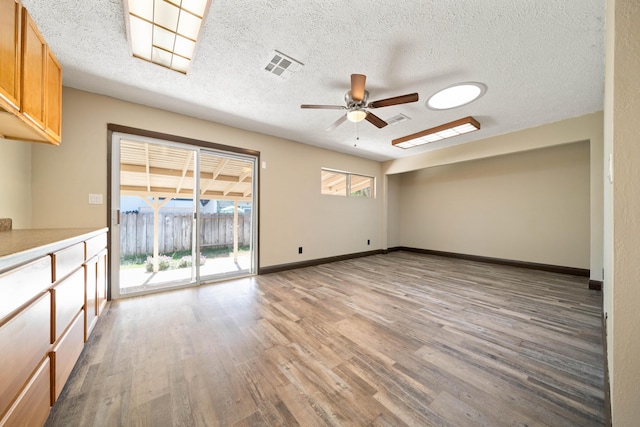 1530 Carmel Way, Red Bluff, CA 96080 - empty room with ceiling fan, light wood-type flooring, a textured ceiling, and baseboards