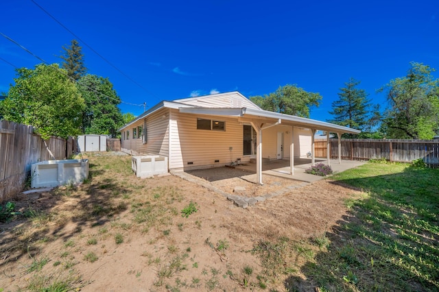1530 Carmel Way, Red Bluff, CA 96080 - back of property featuring a storage unit, a patio area, a fenced backyard, and an outbuilding