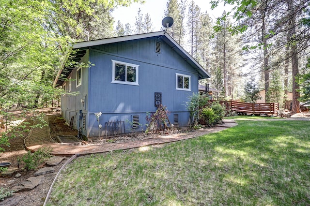 view of home's exterior featuring a lawn and a deck