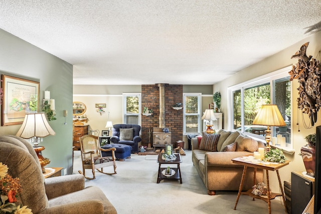 carpeted living room with a wood stove and a textured ceiling