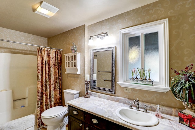 full bath with wallpapered walls, toilet, vanity, and curtained shower
