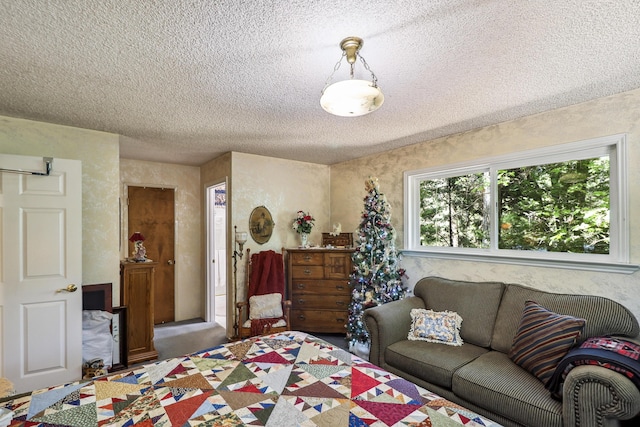 bedroom with a textured ceiling and carpet