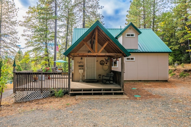 rustic home with metal roof and a deck