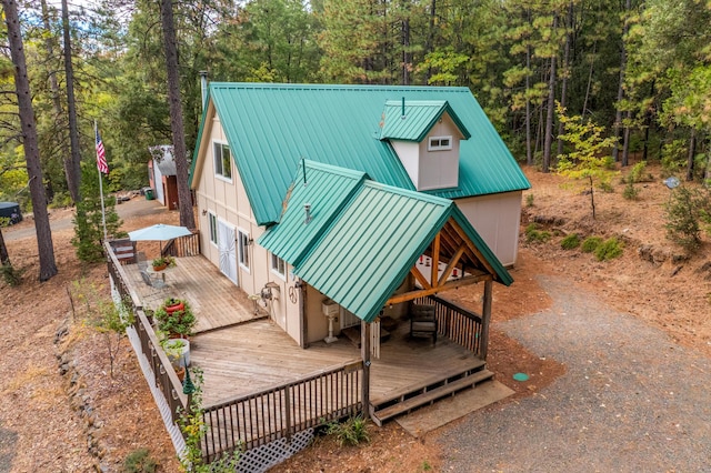 exterior space with metal roof and a wooden deck