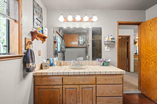 bathroom with a stall shower and vanity