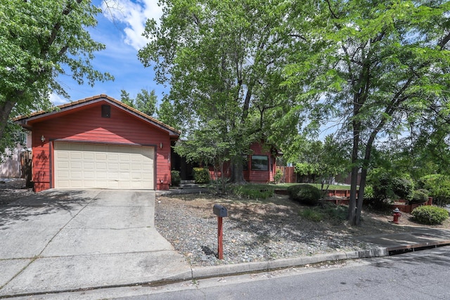 view of front of house with a garage and concrete driveway