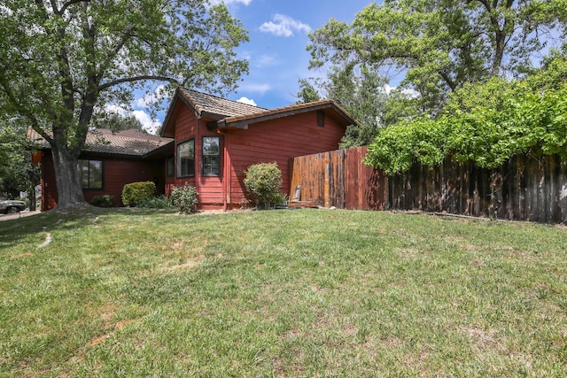 view of home's exterior featuring a tile roof