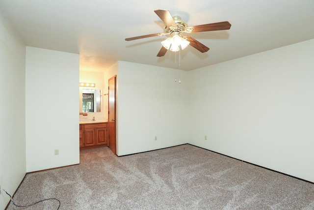 unfurnished room with light carpet and a ceiling fan