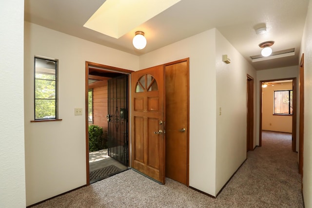 foyer entrance featuring light carpet