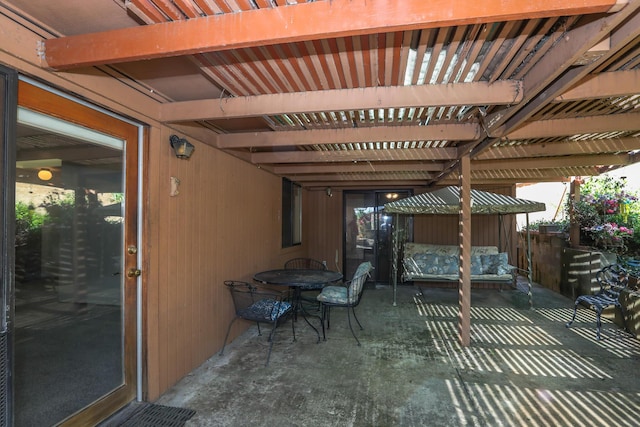 view of patio / terrace with a pergola and outdoor dining space
