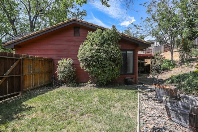 view of home's exterior with a tile roof