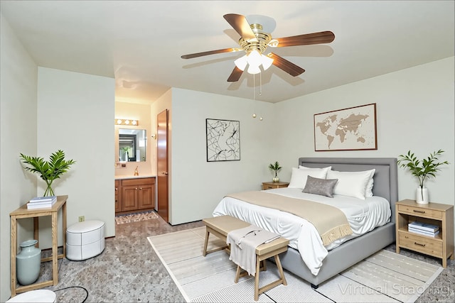 bedroom featuring ensuite bath, a sink, and a ceiling fan