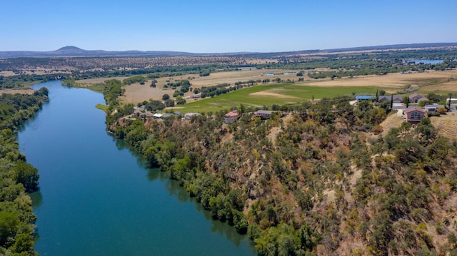 drone / aerial view featuring a water and mountain view