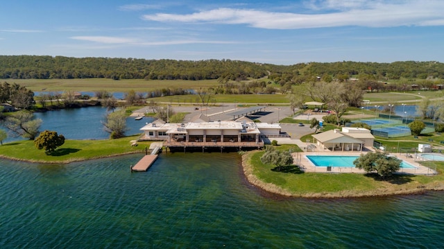 aerial view featuring a forest view and a water view