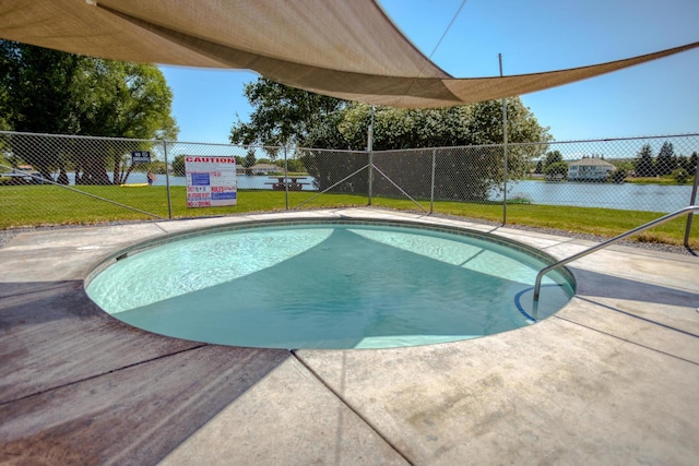 view of pool featuring a lawn, a patio, a fenced in pool, and fence