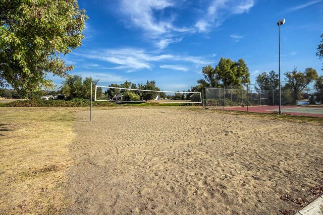 view of community with volleyball court and fence