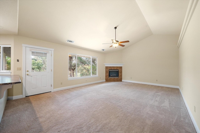 unfurnished living room with lofted ceiling, a wealth of natural light, visible vents, and a ceiling fan