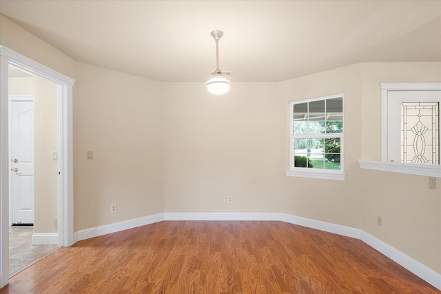 unfurnished room with baseboards and light wood-style floors