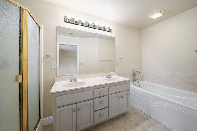 full bath featuring a garden tub, visible vents, a sink, and double vanity