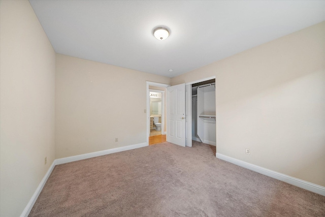 unfurnished bedroom with light carpet and baseboards