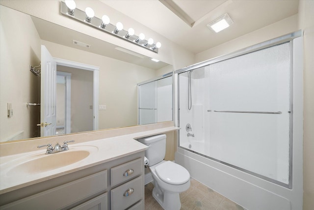 full bath featuring toilet, visible vents, bath / shower combo with glass door, and vanity