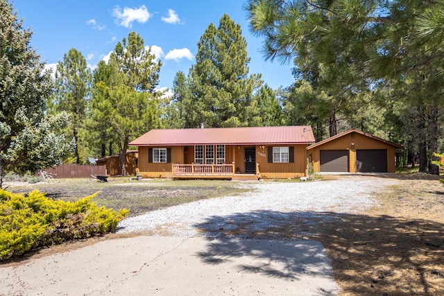 12637 Ivie Ln, Old Station, CA 96071 - single story home with covered porch, metal roof, an outbuilding, and driveway