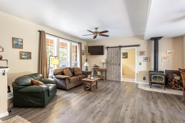 12637 Ivie Ln, Old Station, CA 96071 - living area featuring a ceiling fan, a barn door, wood finished floors, and baseboards