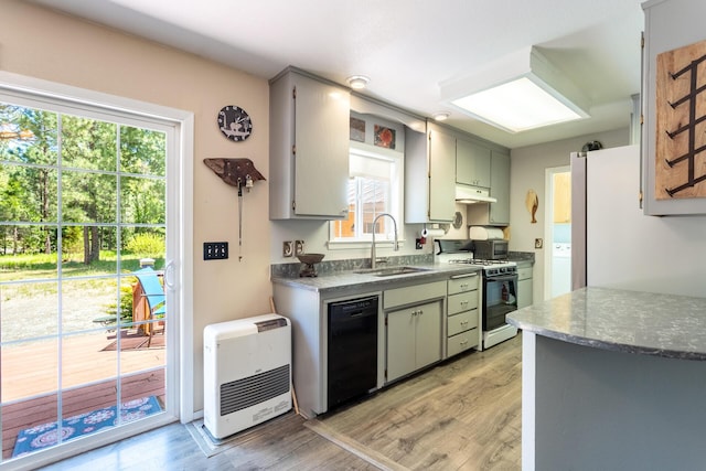12637 Ivie Ln, Old Station, CA 96071 - kitchen with gas range oven, a sink, under cabinet range hood, black dishwasher, and light wood finished floors